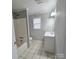 Bathroom featuring a tub, single sink vanity, and neutral walls at 1307 Washington Ln, Kannapolis, NC 28083