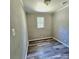 Empty bedroom with vinyl flooring, light walls, a window, and neutral finishes at 1307 Washington Ln, Kannapolis, NC 28083