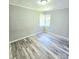 This bedroom features hard surface floors and two windows providing natural light at 1307 Washington Ln, Kannapolis, NC 28083