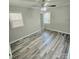 Bedroom with two windows, ceiling fan, and wood-look floors at 1307 Washington Ln, Kannapolis, NC 28083