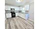 A modern kitchen with white cabinets, granite countertops, and stainless steel appliances at 1307 Washington Ln, Kannapolis, NC 28083