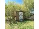 View of a wood shed amongst trees, which includes a closed door with a white X on it at 1307 Washington Ln, Kannapolis, NC 28083