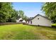 Large, grassy backyard featuring a shed and a privacy fence at 13324 Kintyre Ct, Matthews, NC 28105