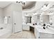 Bathroom with double sinks, white cabinets, and a separate shower and soaking tub offers ample space at 13324 Kintyre Ct, Matthews, NC 28105