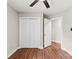 Bright bedroom with hardwood floors, ceiling fan, and closet at 13324 Kintyre Ct, Matthews, NC 28105