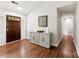 Entryway with wood floors, stylish gray cabinet, decorative accents, and a hallway view at 13324 Kintyre Ct, Matthews, NC 28105