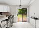 Bright kitchen with backyard access and features a coffee bar and breakfast bar with seating at 13324 Kintyre Ct, Matthews, NC 28105