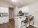 Kitchen with sleek white cabinets, granite countertops, stainless steel appliances, and breakfast bar with stylish seating at 13324 Kintyre Ct, Matthews, NC 28105