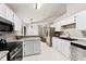 Spacious kitchen features white cabinetry, stainless steel appliances, stone countertops, and a breakfast bar at 13324 Kintyre Ct, Matthews, NC 28105