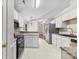 Functional kitchen features ample cabinet space, stainless steel appliances, and views into the living room at 13324 Kintyre Ct, Matthews, NC 28105
