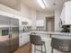 This kitchen features white cabinets, stainless steel appliances, and a breakfast bar with stylish seating at 13324 Kintyre Ct, Matthews, NC 28105