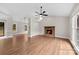 Spacious living room features a brick fireplace, hardwood floors, and large windows for ample natural light at 13324 Kintyre Ct, Matthews, NC 28105