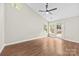 Bright living room with vaulted ceiling, fan, wood floors, windows and glass doors to deck at 13324 Kintyre Ct, Matthews, NC 28105