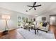 Cozy living area with hardwood floors, fireplace, and a large window offering a bright, inviting space at 13324 Kintyre Ct, Matthews, NC 28105