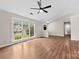 Bright living room showcasing vaulted ceilings, hardwood floors, and large windows with backyard views at 13324 Kintyre Ct, Matthews, NC 28105