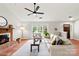 Bright living room featuring hardwood floors, fireplace, and a large window providing lots of natural light at 13324 Kintyre Ct, Matthews, NC 28105