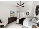 This main bedroom features a vaulted ceiling, a modern ceiling fan, and a large dresser at 13324 Kintyre Ct, Matthews, NC 28105