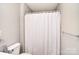 Bright bathroom features a white toilet, shower with white curtain, and a towel rack at 139 High Ridge Rd, Mooresville, NC 28117