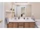 Bathroom with double sinks, a large mirror and wooden cabinets at 139 High Ridge Rd, Mooresville, NC 28117