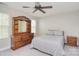Cozy bedroom with natural lighting, ceiling fan and traditional wood furniture at 139 High Ridge Rd, Mooresville, NC 28117