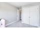 A bedroom with light gray walls and plush carpet, with large closet doors at 139 High Ridge Rd, Mooresville, NC 28117