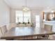 Nicely staged dining area with updated lighting and a door to the outside at 139 High Ridge Rd, Mooresville, NC 28117
