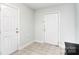 Clean entryway with neutral tile floors and white doors leading to other parts of the house at 139 High Ridge Rd, Mooresville, NC 28117