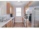 Galley kitchen with stainless steel appliances, wood cabinets, and window at 139 High Ridge Rd, Mooresville, NC 28117