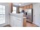 Bright kitchen with stainless steel appliances, wood cabinets, and a ceiling fan at 139 High Ridge Rd, Mooresville, NC 28117