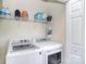 Bright laundry room with modern appliances and storage shelf at 139 High Ridge Rd, Mooresville, NC 28117