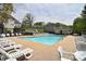 Community pool with ample lounge chairs and a bath house surrounded by mature trees and well-maintained landscaping at 139 High Ridge Rd, Mooresville, NC 28117