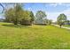 Spacious backyard features lush green lawn and storage shed with lots of space to enjoy the outdoors at 146 37Th Nw St, Hildebran, NC 28601