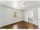Bright bedroom featuring hardwood floors and a sun-filled window looking out onto a green outdoor view at 146 37Th Nw St, Hildebran, NC 28601