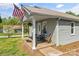 Cozy front porch with seating, perfect for enjoying peaceful moments outdoors with an American flag at 146 37Th Nw St, Hildebran, NC 28601