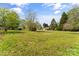 Large front yard with mature trees and beautiful landscaping at 146 37Th Nw St, Hildebran, NC 28601