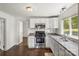 Functional kitchen featuring white cabinets, stainless steel appliances, and hardwood flooring at 146 37Th Nw St, Hildebran, NC 28601
