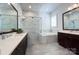Bright bathroom featuring a double vanity, a soaking tub, and a walk-in shower with glass enclosure at 1528 Half Pint Loop, Fort Mill, SC 29708