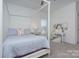 Bright bedroom with a four-poster bed, desk, and ample natural light at 1528 Half Pint Loop, Fort Mill, SC 29708