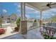 Relaxing covered porch with brick columns, a cozy seating area, and a view of the beautiful neighborhood at 1528 Half Pint Loop, Fort Mill, SC 29708