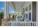 Spacious covered porch with comfortable seating, stylish lighting, and a view of the neighborhood at 1528 Half Pint Loop, Fort Mill, SC 29708