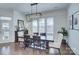 Elegant dining room featuring a dark wood table, stylish chandelier, and bright natural light from large windows at 1528 Half Pint Loop, Fort Mill, SC 29708