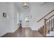 Inviting foyer with hardwood floors, wainscoting, and staircase to the upper level at 1528 Half Pint Loop, Fort Mill, SC 29708