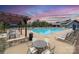 Relaxing pool area with comfortable lounge chairs and shaded seating under a colorful sunset at 1528 Half Pint Loop, Fort Mill, SC 29708