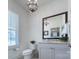 Cozy powder room with a granite vanity, modern fixtures, and a decorative mirror at 1528 Half Pint Loop, Fort Mill, SC 29708