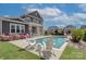Gorgeous swimming pool area with lounge chairs, green grass, and lovely landscaping at 1528 Half Pint Loop, Fort Mill, SC 29708