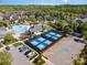 Aerial view of a community with swimming pool, tennis courts, and neatly arranged homes at 19006 Brandon James Dr, Cornelius, NC 28031