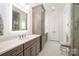 Bright bathroom with a large vanity, storage, tiled floors, and access to the shower at 19006 Brandon James Dr, Cornelius, NC 28031