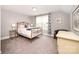 Cozy bedroom features a brass bed frame, patterned curtains, and neutral decor at 19006 Brandon James Dr, Cornelius, NC 28031