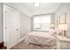 Cozy bedroom with soft natural light, neutral walls, and patterned quilt bedding at 19006 Brandon James Dr, Cornelius, NC 28031