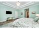 This bedroom includes a TV, seating, an en suite bathroom, and stylish decor at 19006 Brandon James Dr, Cornelius, NC 28031